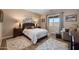 Cozy bedroom with a queen size bed, plush bedding, neutral walls and a view to the landscaped backyard at 3117 S Signal Butte Rd # 484, Mesa, AZ 85212
