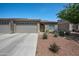 Charming single-story home featuring a three-car garage and desert landscaping in front at 3117 S Signal Butte Rd # 484, Mesa, AZ 85212
