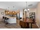 Charming kitchen and dining area with wood floors, pendant lighting, and stainless steel appliances at 3117 S Signal Butte Rd # 484, Mesa, AZ 85212