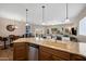 Bright kitchen with stainless dishwasher and sink overlooking the living room and dining areas at 3117 S Signal Butte Rd # 484, Mesa, AZ 85212