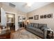 Living room showcasing a comfortable sofa, stylish decor, a ceiling fan, and connecting bathroom at 3117 S Signal Butte Rd # 484, Mesa, AZ 85212