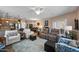 Open concept living room with wood floors, ceiling fan, modern furniture, and access to the kitchen at 3117 S Signal Butte Rd # 484, Mesa, AZ 85212