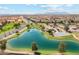 A beautiful aerial view showcases the community pond, green spaces, and surrounding landscape at 36354 W San Clemente Ave, Maricopa, AZ 85138