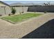 Gravel backyard featuring a patch of lush green grass at 36354 W San Clemente Ave, Maricopa, AZ 85138