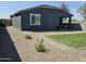 Backyard view features a covered patio and landscaped gravel yard at 36354 W San Clemente Ave, Maricopa, AZ 85138