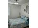 Cozy bedroom with neutral tones, a decorative window, and an inviting bed at 36354 W San Clemente Ave, Maricopa, AZ 85138
