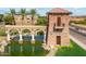 Stone entrance to Tortosa with water feature and palm trees creating an inviting welcome at 36354 W San Clemente Ave, Maricopa, AZ 85138