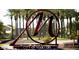Large metal sign identifying the City of Maricopa, set amongst mature palm trees at 36354 W San Clemente Ave, Maricopa, AZ 85138