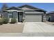 Charming single-story home features a two-car garage, a gray color scheme, and manicured landscaping at 36354 W San Clemente Ave, Maricopa, AZ 85138