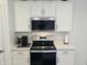 Clean kitchen has white cabinets, subway tile backsplash, and stainless steel appliances at 36354 W San Clemente Ave, Maricopa, AZ 85138