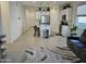 The large living area has tile floors, a gray couch, and sliding doors to the backyard at 36354 W San Clemente Ave, Maricopa, AZ 85138