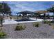 Community picnic area with tables, barbecue grill, and playground in a well-maintained space at 36354 W San Clemente Ave, Maricopa, AZ 85138