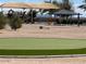 A modern playground with shade canopy and play equipment within a well-maintained community park at 36354 W San Clemente Ave, Maricopa, AZ 85138