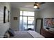 Bright bedroom featuring a ceiling fan, modern decor, and access to an outdoor patio at 3650 E Montecito Ave # 4, Phoenix, AZ 85018