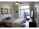 Serene bedroom with a sliding door to an outdoor seating area, soft lighting, and a calming color palette at 3650 E Montecito Ave # 4, Phoenix, AZ 85018
