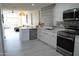 Modern kitchen with white cabinets, stainless steel appliances, and an island at 3650 E Montecito Ave # 4, Phoenix, AZ 85018