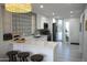 Bright kitchen featuring sleek white cabinets, a quartz countertop island with barstool seating, and modern appliances at 3650 E Montecito Ave # 4, Phoenix, AZ 85018