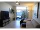Comfortable living room with a sliding glass door to the outdoor space, complemented by a ceiling fan and stylish decor at 3650 E Montecito Ave # 4, Phoenix, AZ 85018