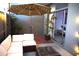 Patio with a white sectional couch and umbrella with brick wall and string lights at 3650 E Montecito Ave # 4, Phoenix, AZ 85018