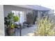 Cozy patio with seating area, potted plants, gray pavers, and sliding glass doors at 3650 E Montecito Ave # 4, Phoenix, AZ 85018