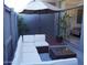 Back patio with a white sectional couch and umbrella with plants and brick wall at 3650 E Montecito Ave # 4, Phoenix, AZ 85018