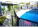 Community pool area with lounge chairs, fence, grass, and sign at 3650 E Montecito Ave # 4, Phoenix, AZ 85018