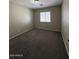 This is a carpeted bedroom that has a window to bring in natural light at 3700 E Sandwick Dr, San Tan Valley, AZ 85140