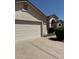 A view of the home's attached garage and landscaped front yard at 3700 E Sandwick Dr, San Tan Valley, AZ 85140