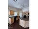 An eat-in kitchen with wood cabinets, dark countertops, an island, and recessed lighting at 3700 E Sandwick Dr, San Tan Valley, AZ 85140