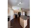 A kitchen features wood cabinets, dark countertops and appliances, and an island at 3700 E Sandwick Dr, San Tan Valley, AZ 85140