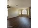 Spacious living room featuring hardwood floors and ample natural light from large windows at 3700 E Sandwick Dr, San Tan Valley, AZ 85140