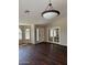 Open-concept living area with hardwood floors and glass panel french doors at 3700 E Sandwick Dr, San Tan Valley, AZ 85140