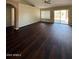 Open-concept living room with hard wood floors and access to the backyard at 3700 E Sandwick Dr, San Tan Valley, AZ 85140