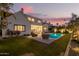 Stunning backyard with a sparkling pool, lush lawn, and relaxing lounge area at 4007 N 34Th St, Phoenix, AZ 85018