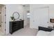 Stylish bedroom with a dark dresser, round mirror, sliding closet doors and neutral decor for a relaxing ambiance at 4007 N 34Th St, Phoenix, AZ 85018