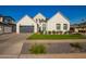 Beautiful two-story modern farmhouse showcases a lush green lawn, a large garage, and stylish landscaping at 4007 N 34Th St, Phoenix, AZ 85018