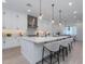 The kitchen features a large central island with bar seating, pendant lighting, and modern white cabinets at 4007 N 34Th St, Phoenix, AZ 85018