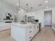 A modern kitchen with large island flows seamlessly into the living area with fireplace at 4007 N 34Th St, Phoenix, AZ 85018
