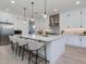 Modern kitchen features white cabinets, a large island with seating, and stainless steel appliances at 4007 N 34Th St, Phoenix, AZ 85018
