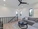 Bright living room with modern decor, ceiling fan, and staircase access at 4007 N 34Th St, Phoenix, AZ 85018