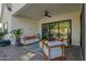 Inviting covered patio with comfortable seating, ceiling fan, and seamless indoor-outdoor flow at 4007 N 34Th St, Phoenix, AZ 85018