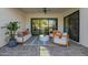 Inviting covered patio with comfortable seating, ceiling fan, and seamless indoor-outdoor flow at 4007 N 34Th St, Phoenix, AZ 85018
