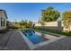 Beautiful pool surrounded by lush landscaping and a spacious patio area with manicured lawn at 4007 N 34Th St, Phoenix, AZ 85018