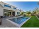 Expansive backyard with a refreshing pool, covered patio, and lush lawn, perfect for entertaining at 4007 N 34Th St, Phoenix, AZ 85018
