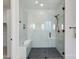 Modern bathroom showcasing a glass-enclosed shower with white marble, bench, and dark bronze fixtures at 4007 N 34Th St, Phoenix, AZ 85018