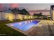 Beautifully landscaped backyard featuring a sparkling pool, lush lawn, and privacy wall at 4007 N 34Th St, Phoenix, AZ 85018