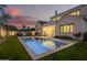 Backyard oasis with a sparkling pool, well-manicured lawn, and stylish lounge seating at 4007 N 34Th St, Phoenix, AZ 85018