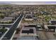 An aerial perspective of a planned community with homes featuring solar panels, set amongst landscaped streets and green spaces at 4115 S 180Th Dr, Goodyear, AZ 85338
