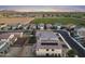 Gorgeous aerial view of a desert neighborhood with farmland in the background at dusk at 4115 S 180Th Dr, Goodyear, AZ 85338