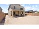 Backyard featuring a covered patio, dining table, and a large dirt lot at 4115 S 180Th Dr, Goodyear, AZ 85338